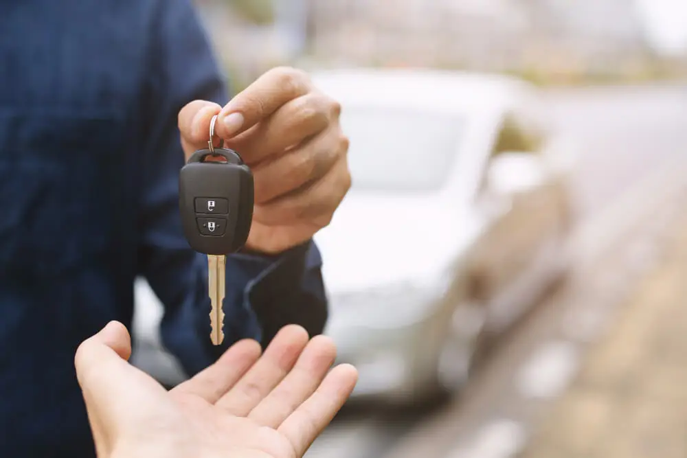 Car Key Businessman Handing Gives Car Key Other Woman Car Background (1)